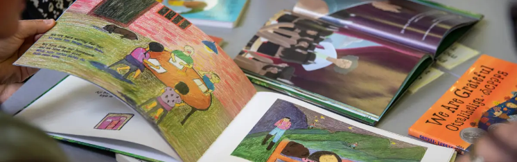 A picturebook is held open on a desk