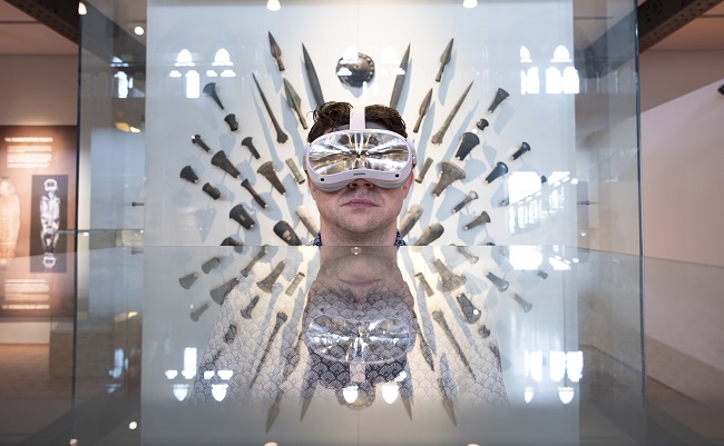 Professor Neil McDonnell who is principal investigator of the Museums in the Metaverse project at the University of Glasgow, is photographed in front of a display at The Hunterian. Photo credit Martin Shields.