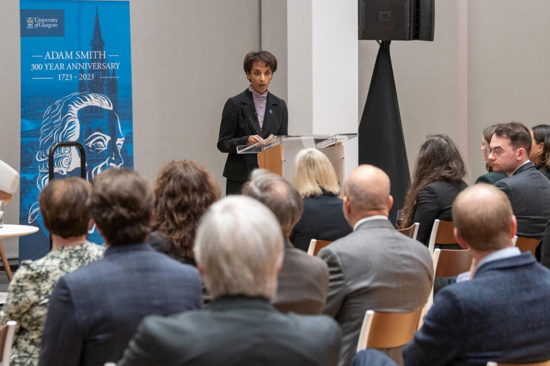 Cecilia Rouse standing towards an audience with a Lectern in front of her Source: Charlotte Morris 