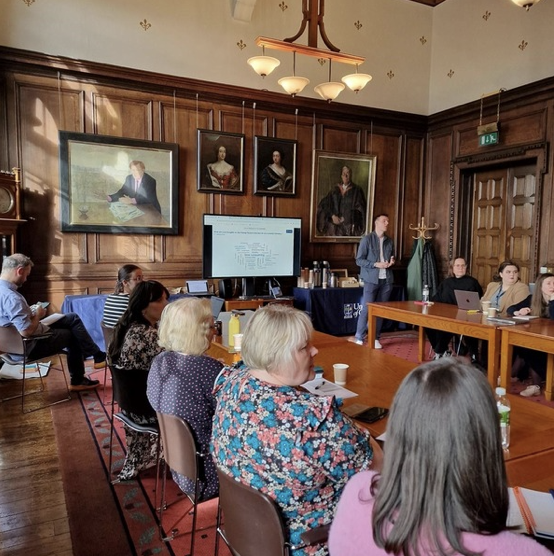 Meeting of a group of people facing speaker