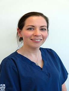 Headshot image of Katie McNaught wearing blue scrubs