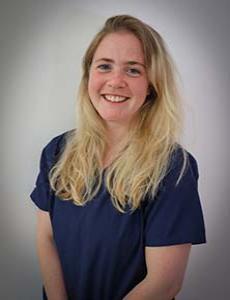 Headshot of Emily Fulton wearing blue scrubs