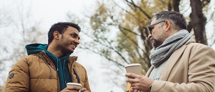 Two men having a discussion outside