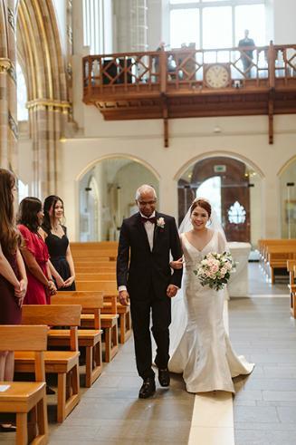 Sandosh walking student down the aisle