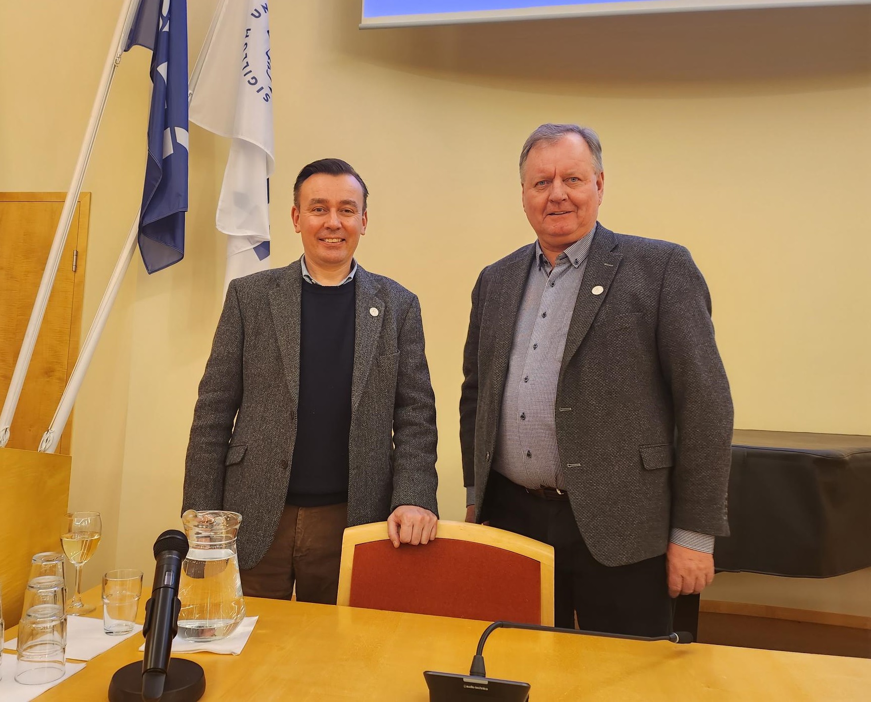 Craig Smith is standing with a speaker at the University of Iceland Smith around the world event. Source: Charlotte Morris