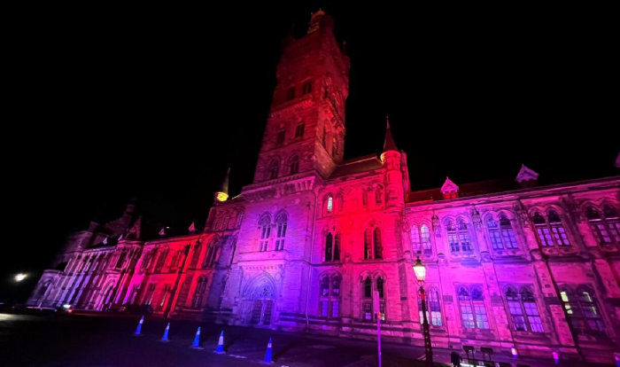 Photo of the main campus tower in red display for World AIDS Day