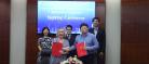 Head of Adam Smith Business School standing for a group photo with associates in China, signing a Memorandum of Agreement