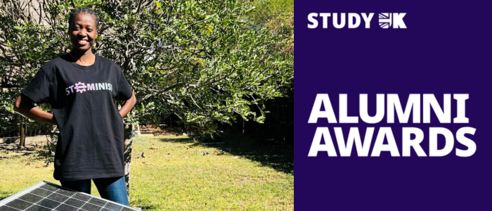 Eunice stands with her arms crossed, smiling, before a solar panel. The Study UK Alumni Award logo can be seen to the right.