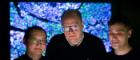 Dr Ke Yuan, Professor John Le Quesne and Dr Adalberto Claudio Quiros stand in front of a projection of one of the cancer sample slides used to train the machine learning algorithm used in the study.