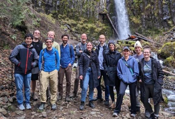 Image of 10 people in the transmissible vaccine team in a forest