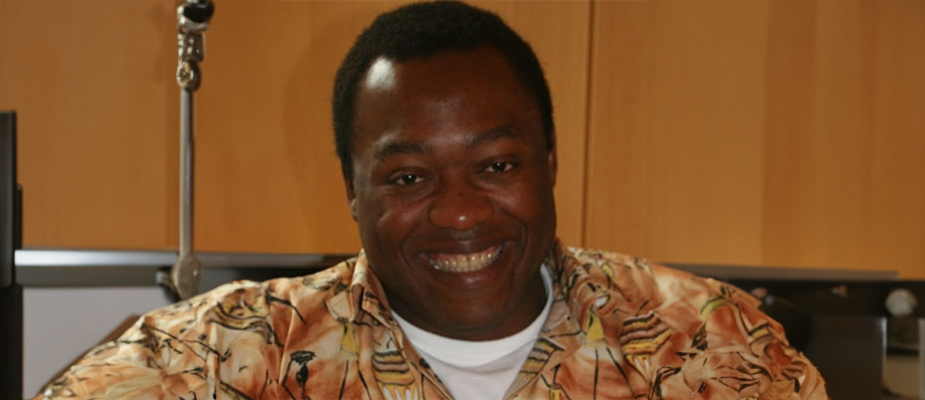 Person sitting at a table wearing a bright shirt