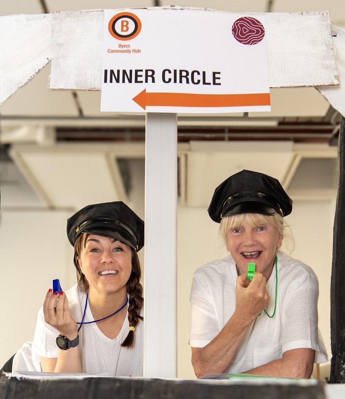 Byres Community Hub Day Actors blowing whistles in front of our ticket booth