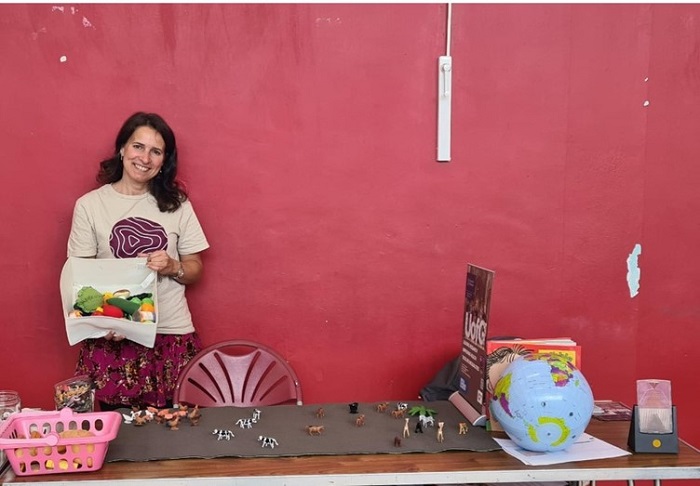 Jana Anderson at STEM at Gorbals in front of stall with toys on desk