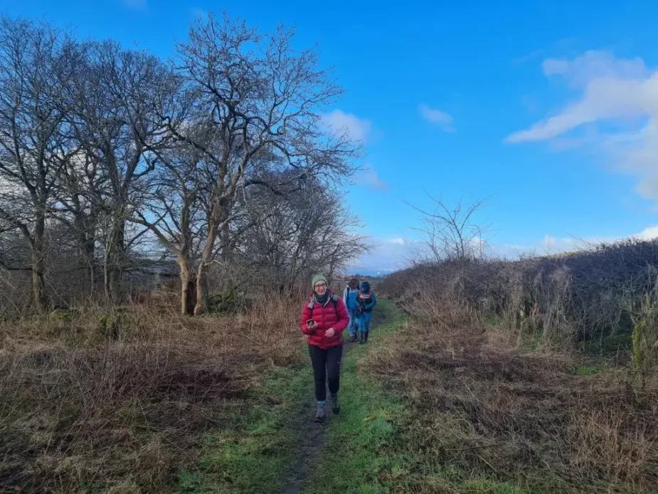 Alison Phipps, Bella Hoogeveen and Jennifer McArthur walking on a dirt path