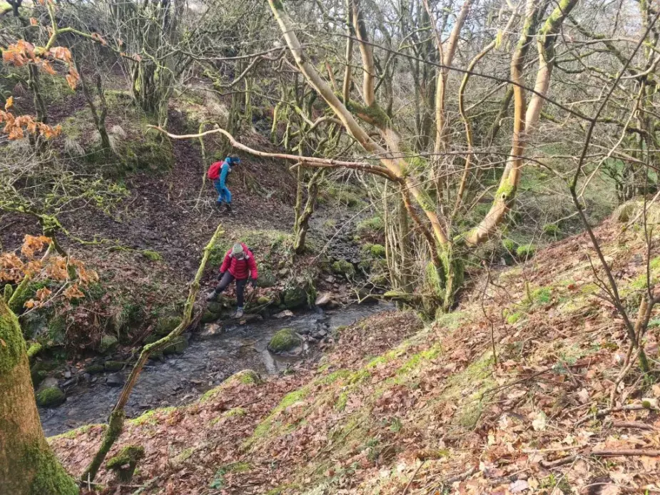 Bella Hoogeveen and Alison Phipps coming downhill to cross a small stream