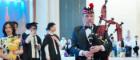 The piper at our 2024 graduation ceremony in Chengdu with graduands and families