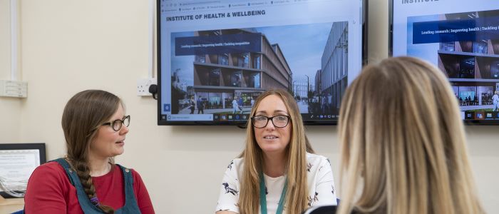 picture of 3 female staff in meeting room