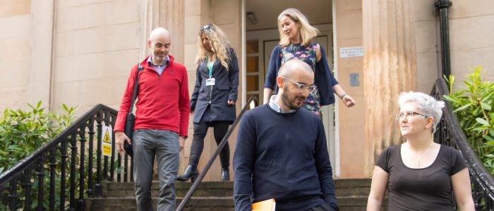 Photo of staff on steps outside General Practice and Primary Care