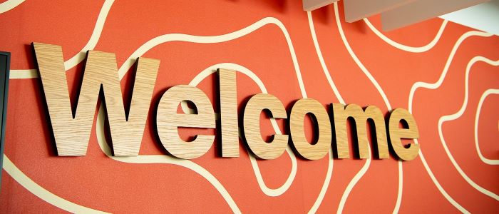 A large welcome sign in the Clarice Pears building at University of Glasgow