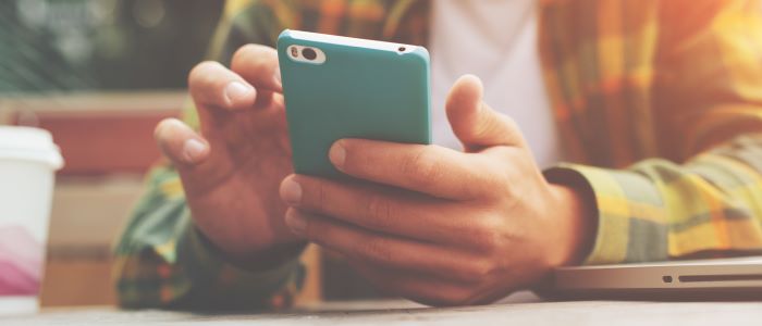 Photo of young male researcher with mobile phone