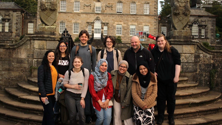 A group of students standing in front of Pollok House in Glasgow