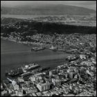 An aerial photograph (by Whites Aviation Ltd) of the Gourock Ropeworks' office (location indicated by a small white arrow and circle in the bottom left hand corner) in Wellington, New Zealand, c1920s.  (GUAS Ref: UGD 42/9/4/4. Copyright reserved.) 