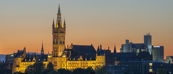 University of Glasgow main building lit up at sunset