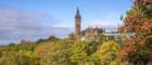 University of Glasgow main building in coloured trees during autumn