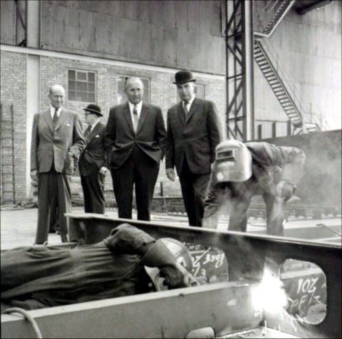 The welders demonstrating their skills to the Cunard visitors.