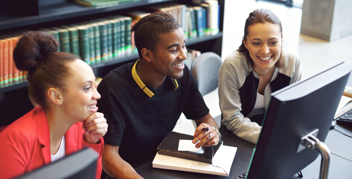 Photo of young researchers working together at a computer