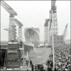 The QE2 is cheered by the crowds.