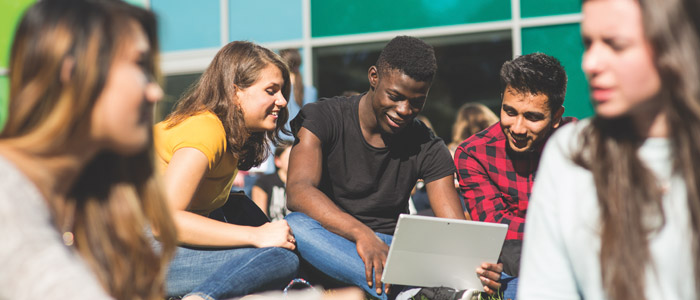 Students on grass outside the Fraser Building