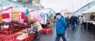 Glasgow, people walking around the historic Barras Market Place flea market. 768x512px