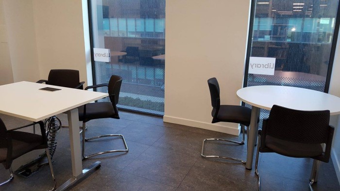 Flat floored training room with groups of tables and chairs 