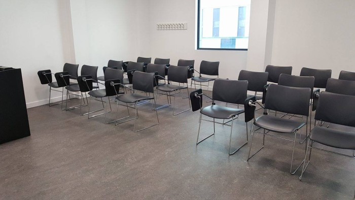 Flat floored teaching room with rows of tablet chairs