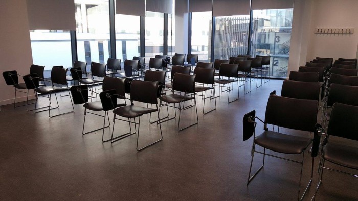 Flat floored teaching room with rows of tablet chairs