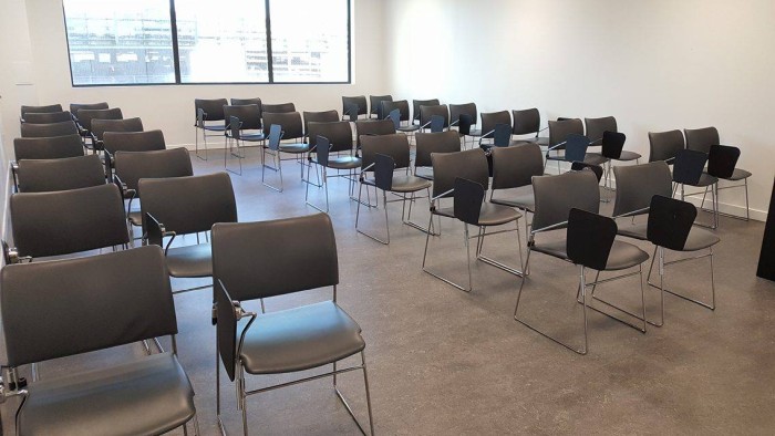 Flat floored teaching room with rows of tablet chairs