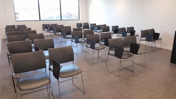 Flat floored teaching room with rows of tablet chairs