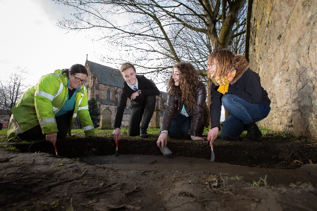 Nicola Reid, Field Archaeolgist, Northlight Heritage; Mark McGettigan, aged 14; Megan Kasten, Project Office & Volunteer, Northlight Heritage and Ingrid Shearer, Community Engagement Officer for Stones & Bones excavation, Northlight Heritage examining one of the three Govan Stones rediscovered at Govan Old Parish Church.