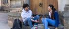 Two students sitting in the quadrangle