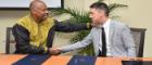 Professor Sir Hilary Beckles (seated left), Vice-Chancellor of The University of the West Indies (The UWI) and Dr. David Duncan, Chief Operating Officer & University Secretary, University of Glasgow, shake hands following the signing of the Memorandum of Understanding at The UWI Regional Headquarters, Kingston, Jamaica on July 31, 2019, to partner in a reparations strategy