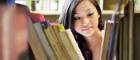 Female student browsing shelves in University of Glasgow library