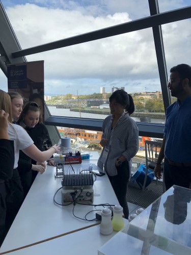 Ultrasound researchers talk about their exhibit with schoolchildren