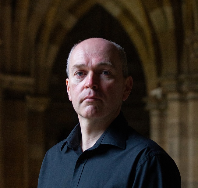 University of Glasgow’s Celtic and Gaelic Lecturer Gillebride MacMillan who played Gwyllyn the Bard in the first series of Outlander 