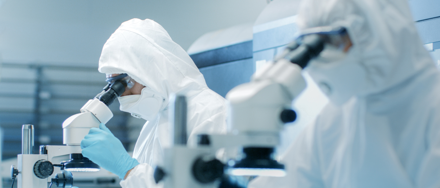 Scientists looking through microscopes