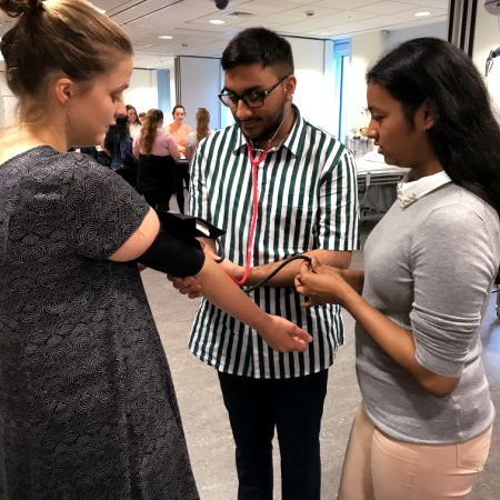 Pupils on the Reach Programme Medicine Summer School gaining experience in taking blood pressure