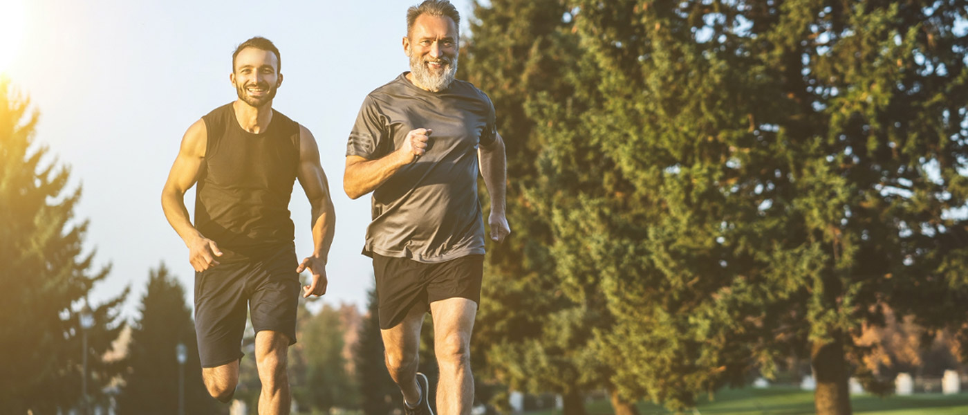 Two men running in park