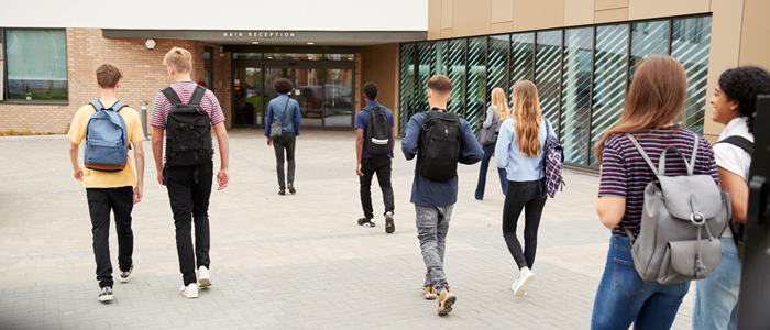 Photo of teenage students outside school