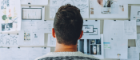 Back of man's head looking at notice board