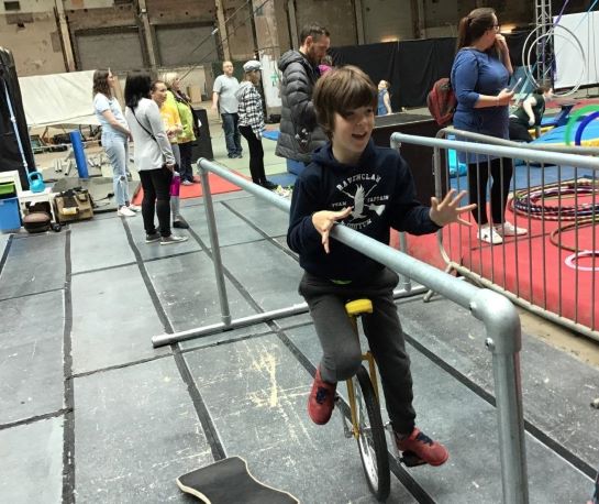 young boy on a unicycle